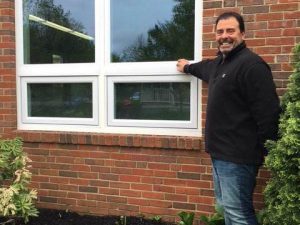 Man standing next to a new window